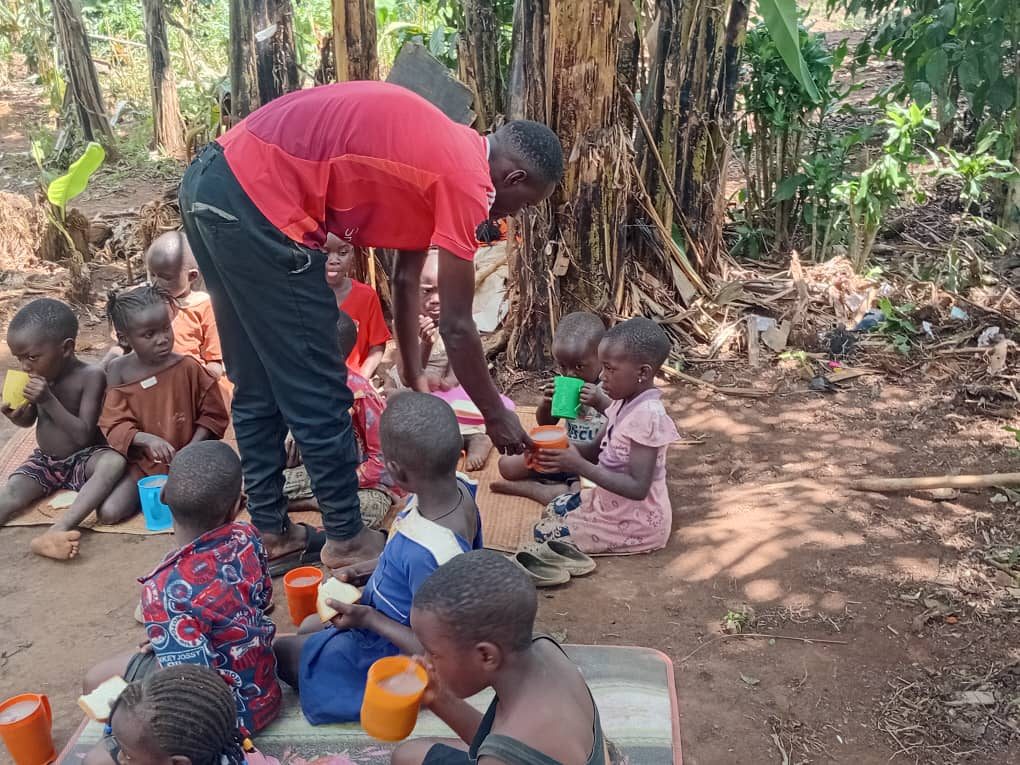 A volunteer serving children at SafeHaven
